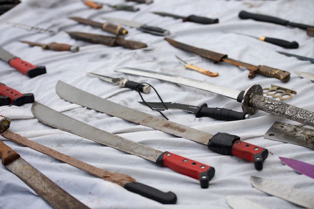 Knives and other weapons that have been deposited into weapon surrender bins (Jacob King/PA)