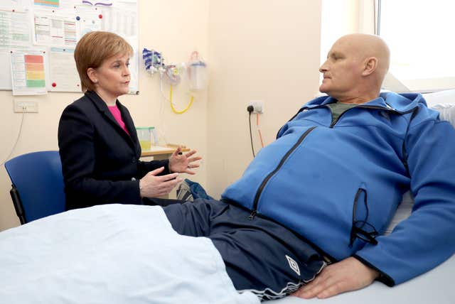 First Minister Nicola Sturgeon met patient Thomas Crawford during a visit to Edinburgh Royal Infirmary (Jane Barlow/PA)