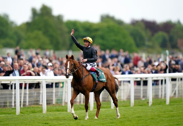 Frankie Dettori waves to spectators after winning the Paddy Power Yorkshire Cup on Stradivarius