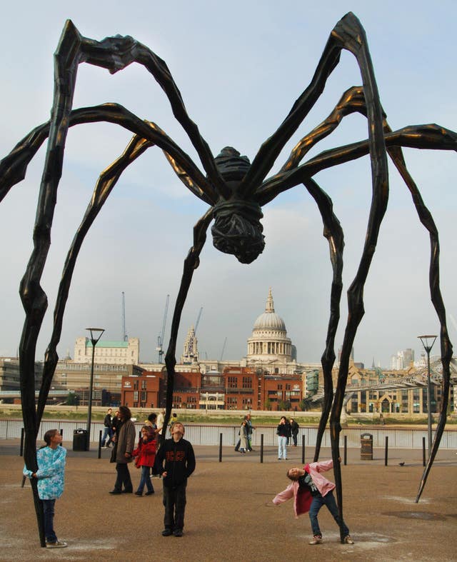 A sculpture by French-born artist Louise Bourgeois of a giant spider, Maman 1999, stands outside Tate Modern gallery in London