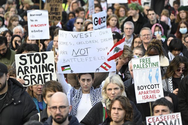 People take part during a silent funeral procession through Edinburgh city centre as part of the Scottish National Demonstration for Palestine