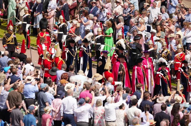 The King and Queen watched by crowds of people in their robes arrive to attend the annual Order of the Garter Service at St George’s Chapel
