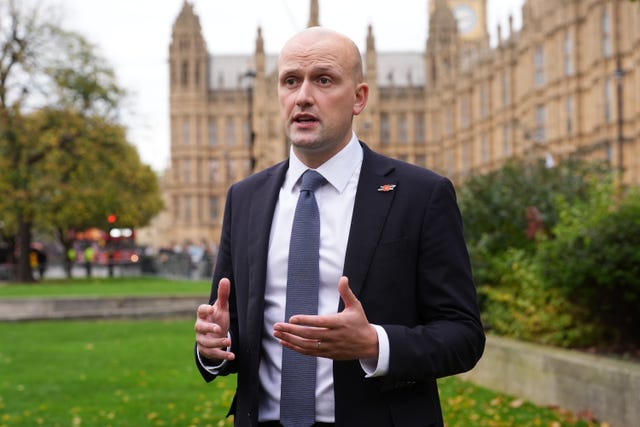 Stephen Flynn speaking while standing outside the Houses of Parliament