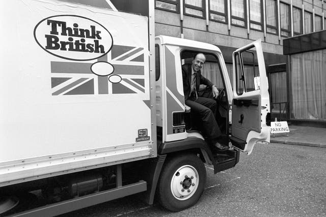 Norman Tebbit in a lorry with a Union flag on it and the words 'Think British'