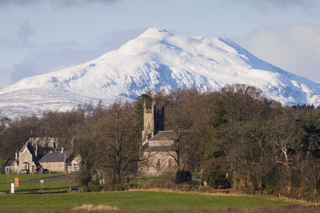 A view of snow-covered peaks in the Loch Lomond and Trossachs National Park behind Kincardine in Mentieth church and schoolhouse in Stirlingshire. (John Linton/PA)