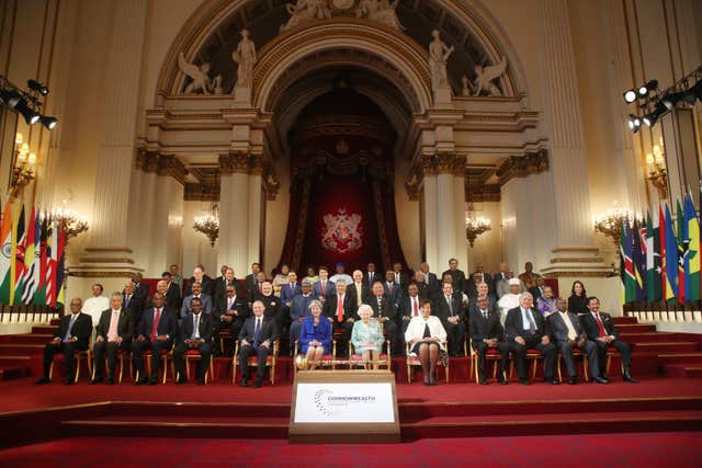The world leaders and the Queen pose for the traditional Commonwealth 
