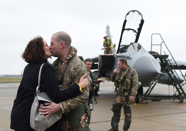 A serviceman is welcomed home by his partner