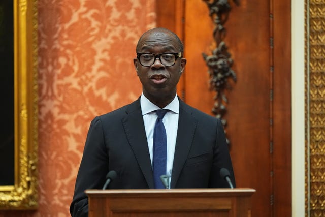 Clive Myrie speaking from behind a lectern