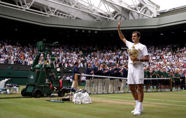 Roger Federer celebrates with the trophy at Wimbledon