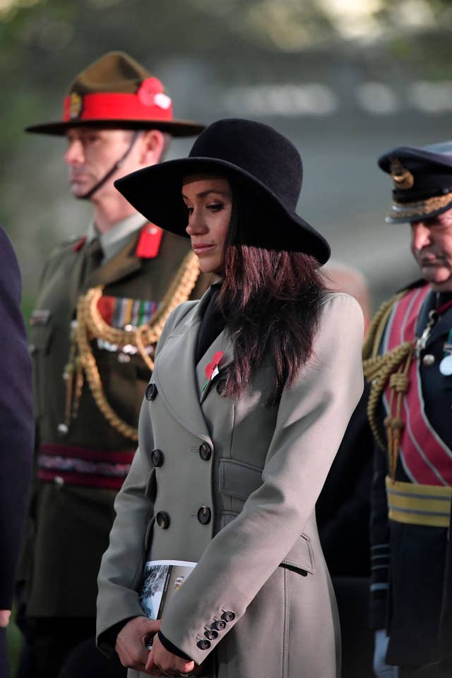 Ms Markle wore a grey coat and large brimmed hat (Toby Melville/PA)