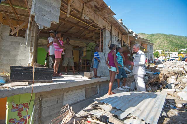 The Prince of Wales talks to residents in Pointe Michel on Dominica during his tour of hurricane-ravaged Caribbean islands