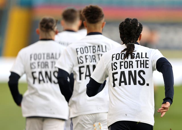 Leeds United players wearing ‘Football Is For The Fans’ shirts during the warm up for their Premier League match with Liverpool (Clive Brunskill/PA)