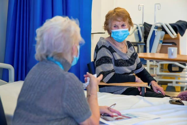 Margaret Keenan, (right), 91, chats with Betty Miller, 90, after they both received their second dose of the Pfizer/BioNtech Covid-19 vaccine at University Hospital, Coventry (Jonny Weeks/The Guardian/PA)