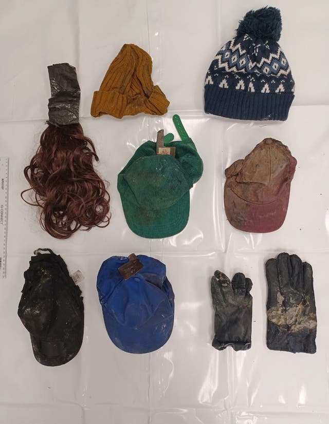 Police evidence including hats, gloves and a wig with tape attached to it