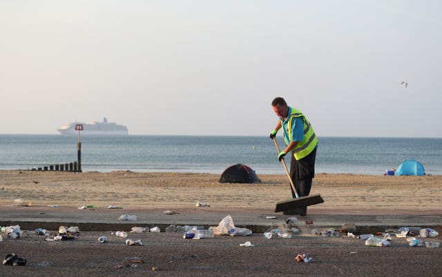 The clean-up gets under way after a busy Saturday on the beach