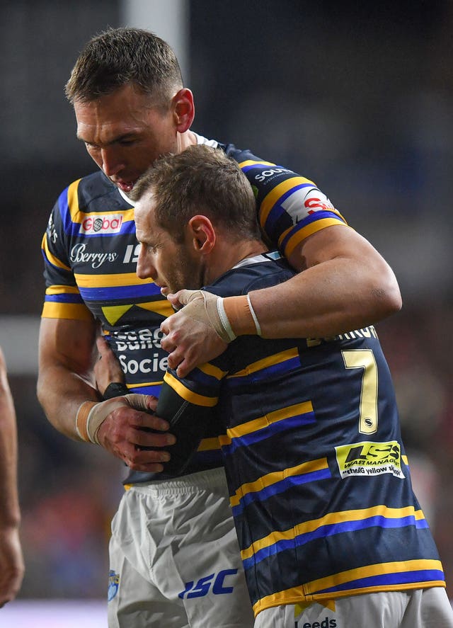 Rob Burrow is embraced by fellow Leeds great Kevin Sinfield (left) after the testimonial match at Headingley