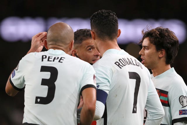 Pepe and Cristiano Ronaldo talk to the referee
