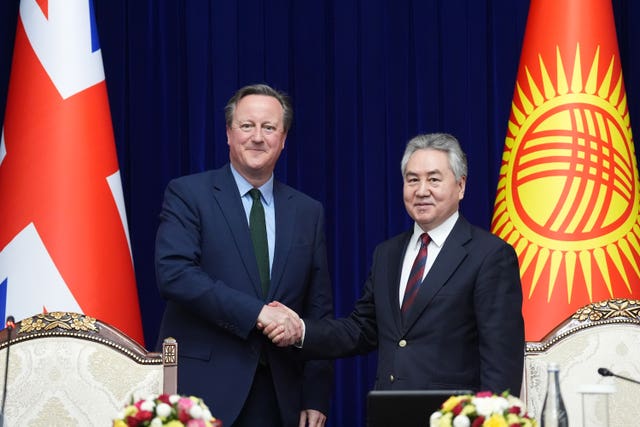 Foreign Secretary Lord David Cameron shakes hands with the minister of foreign affairs of the Kyrgyz Republic Jeenbek Kulubaev