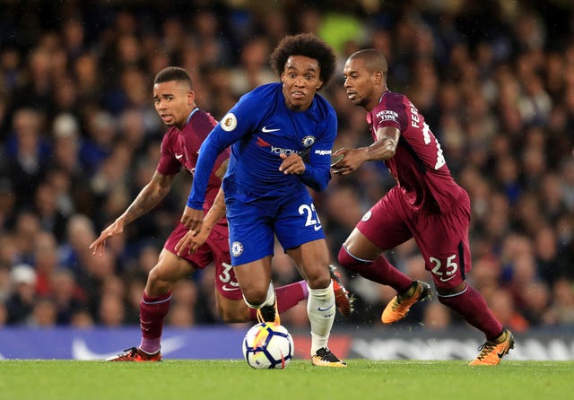 Willian, centre, in action for Chelsea against Manchester City's Fernandinho, right, and Gabriel Jesus