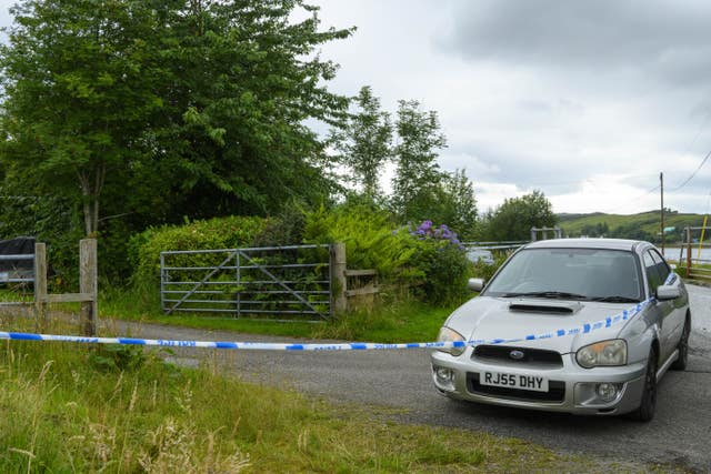 Area of land and a car taped off with police tape