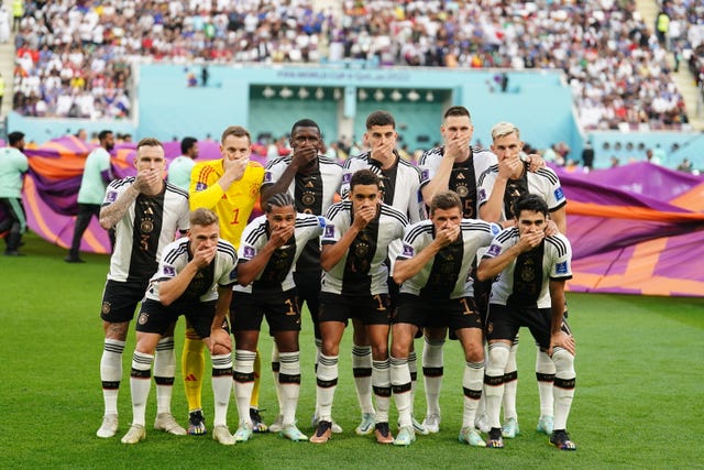 Germany's players cover their mouths in support of the OneLove campaign before their opening World Cup Group E game against Japan