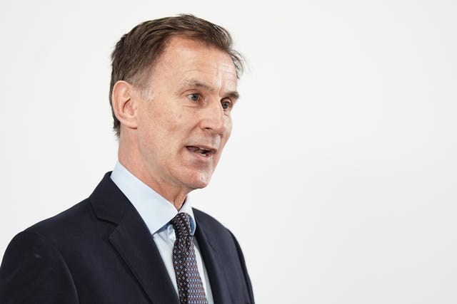 Jeremy Hunt giving a speech standing in front of a plain white background