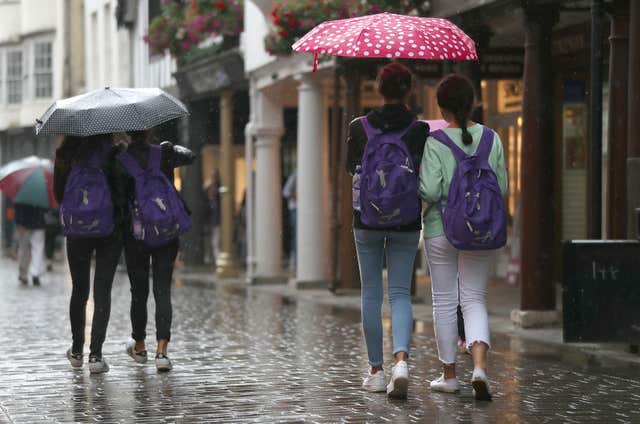 Shoppers with umbrellas on Winchester's high street 