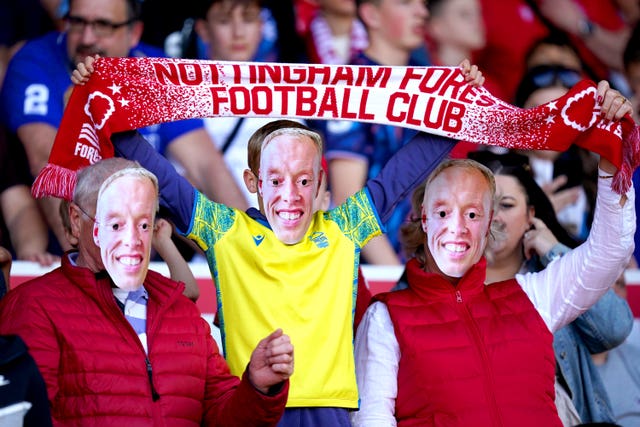 Nottingham Forest fans wearing Steve Cooper masks at the game against Arsenal