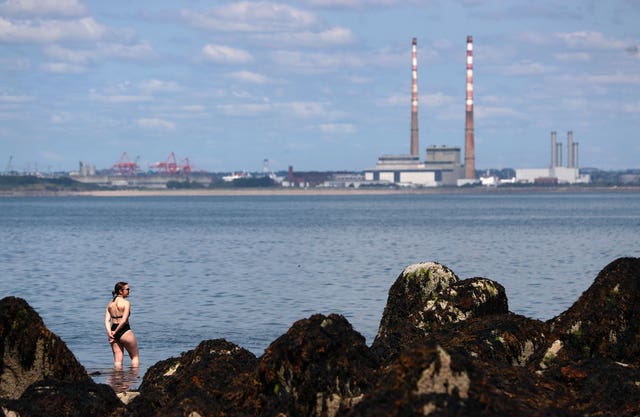 A woman makes her way into the sea at Seapoint in Dublin on a hot summer’s day