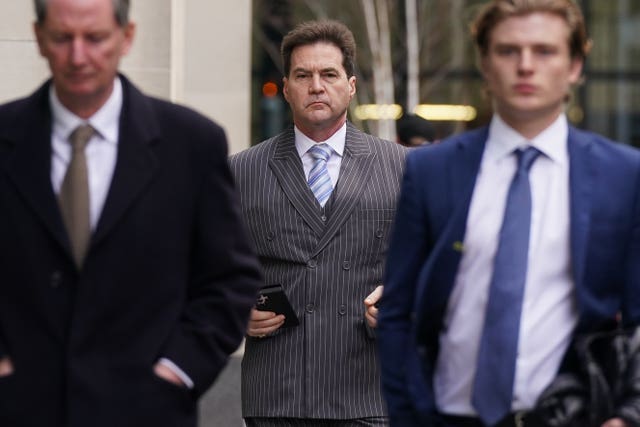 Dr Craig Wright, centre, arrives at the Rolls Building in London 