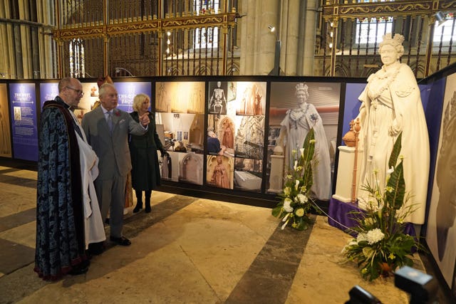 Charles and Camilla are shown a scaled replica of the statue of Queen Elizabeth II 