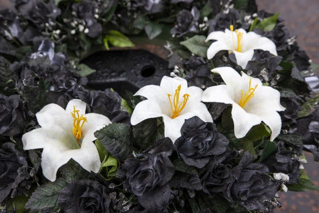 A black wreath with with lillies