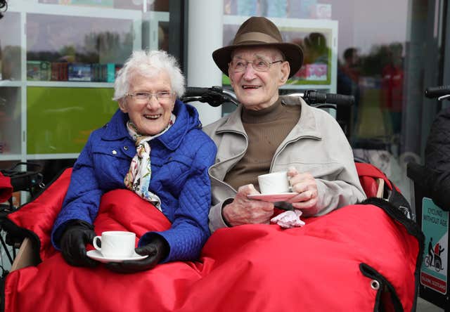 Mary Duncan, 90, and Jim Taylor, 96, enjoy a cup of tea in their trishaw (Andrew Milligan/PA)