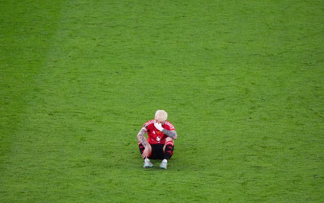 Alejandro Garnacho sits dejected on the pitch following Manchester United’s Europa League final defeat