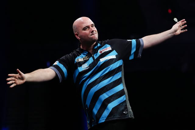 Rob Cross stretches is arms in celebration