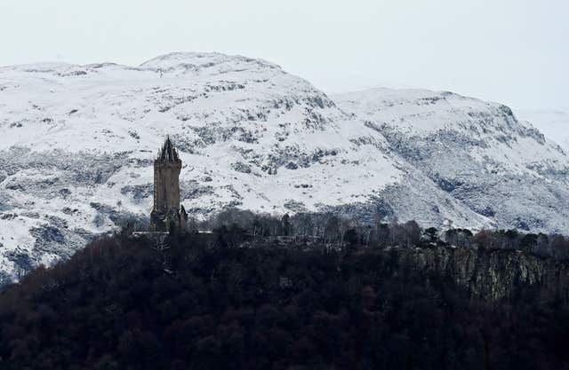 A view of the snow-covered Ochil Hills behind the Wallace Monument in Stirling (Andrew Milligan/PA)