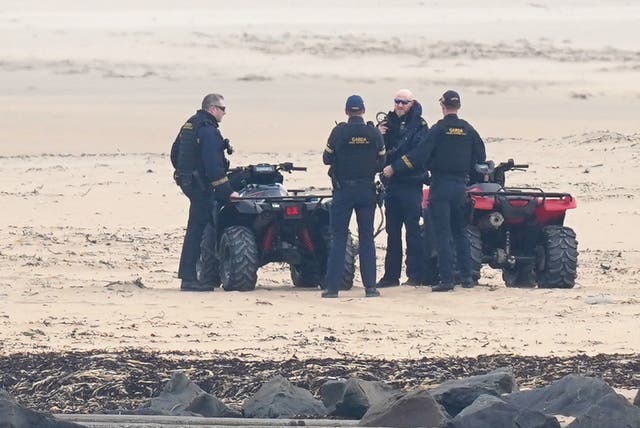 Armed gardai with quad bikes on a ebach