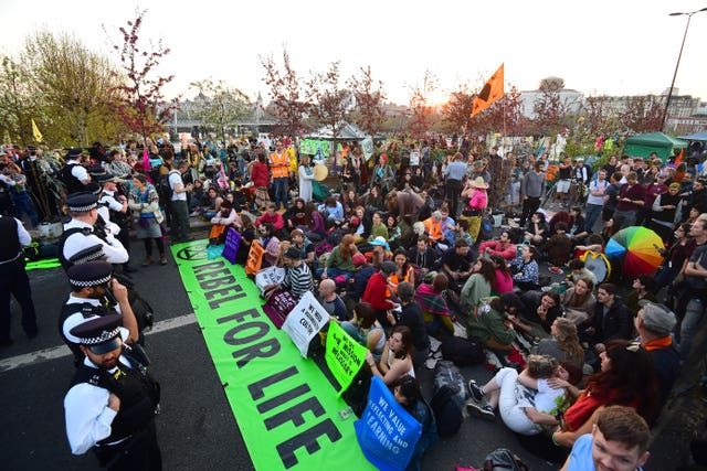 Metropolitan Police and Extinction Rebellion demonstrators face each other on Waterloo Bridge (Victoria Jones/PA)