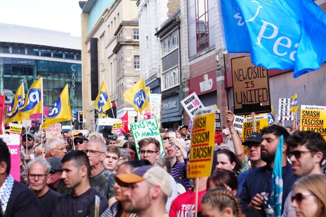 A large group of people holding placards 