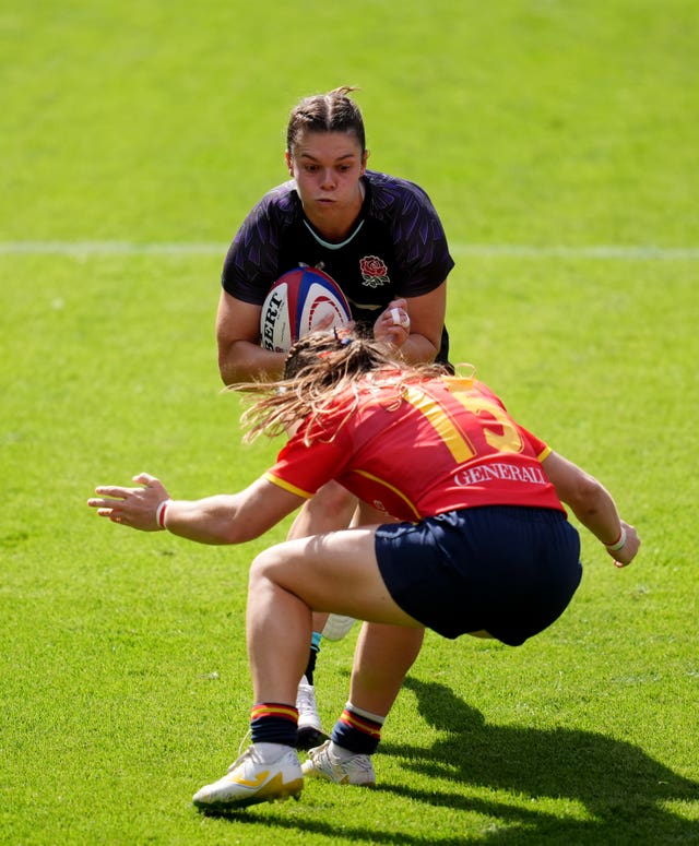 England’s Helena Rowland is tackled by Spain’s Claudia Pena