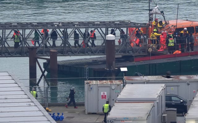 A group of people thought to be migrants are brought in to Dover 