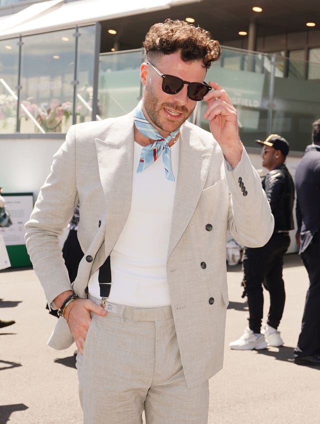 Jordan North arriving at Wimbledon in a light grey suit