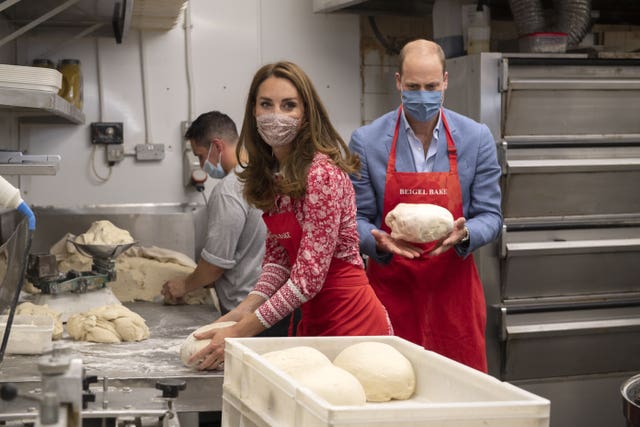 The Duke and Duchess of Cambridge knead dough during a visit to the Beigel Bake Brick Lane Bakery in London