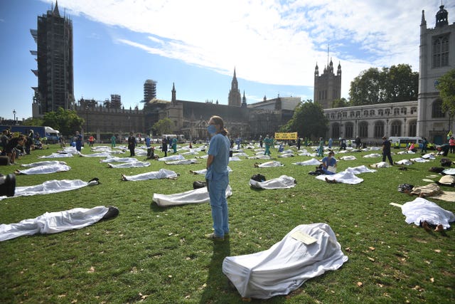 Extinction Rebellion protesters pose as corpses during a protest in Parliament Square 