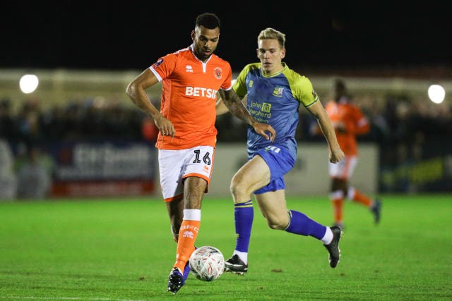 Curtis Tilt (left), then of Blackpool, battle for the ball with Solihull Moors' Jermaine Hylton