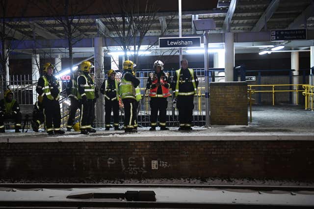 Emergency workers at Lewisham station after passengers frustrated by delays jumped from trains and walked down tracks near the station (Victoria Jones/PA)
