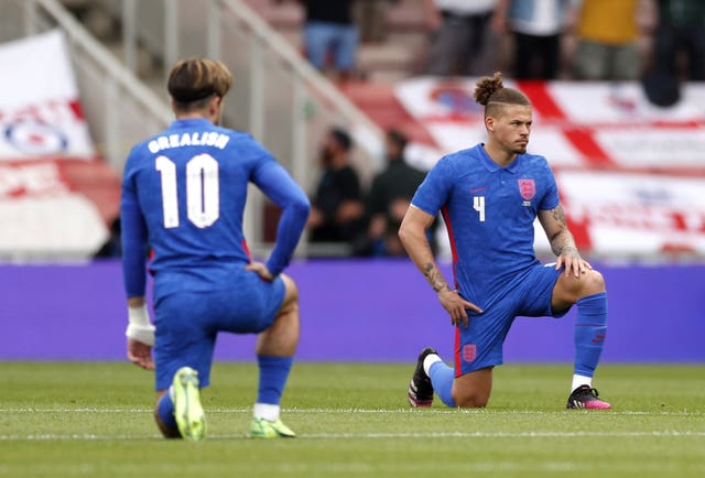 Kalvin Phillips, right, takes a knee in support of the fight against racism before England's friendly with Romania