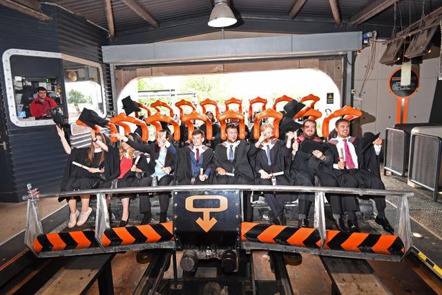 Students at a graduation ceremony on Alton Towers' Oblivion ride