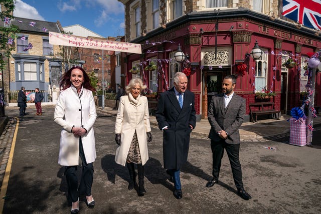 The then-Duchess of Cornwall and then-Prince of Wales with Chris Clenshaw on a visit to the set of EastEnders in 2022