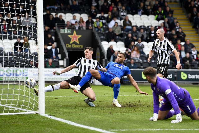 James Bolton, left, scores an own goal under pressure from Rangers' Cyriel Dessers